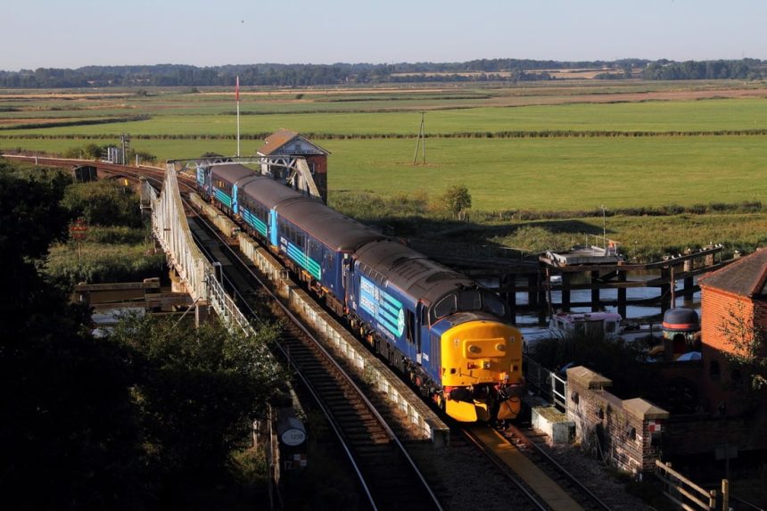 Two Class 37 diesels top and tail a service train over the Reedham Swing Bridge in 2016