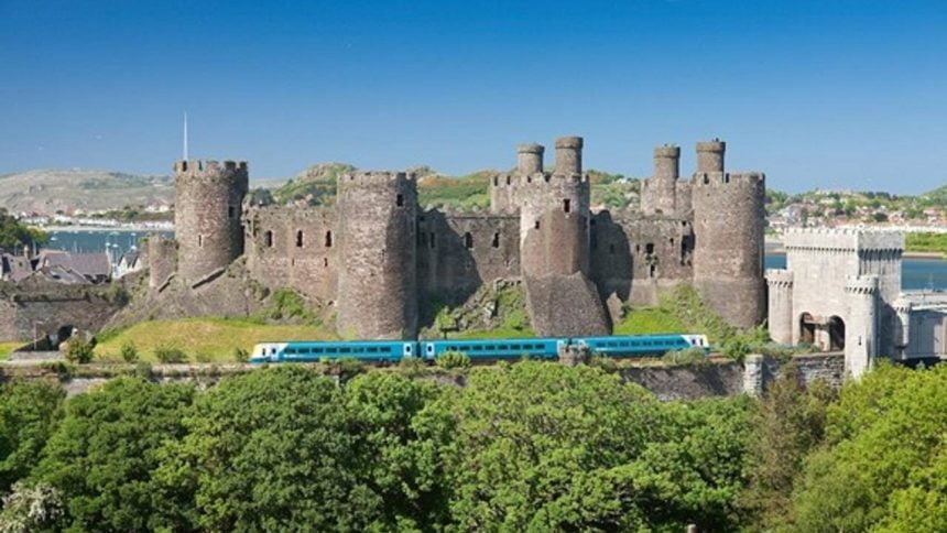 Conwy castle with an Arriva Trains Wales service for Holyhead