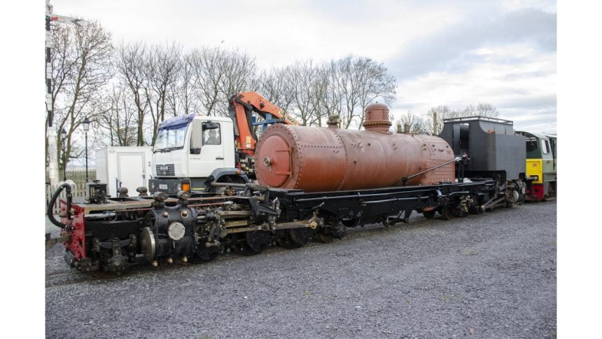 The new boiler for NG/G16 130 arrives at Dinas by road and is lifted on to the frames of the locomotive.