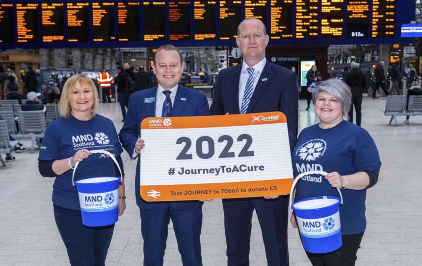 GLASGOW, SCOTLAND - FEBRUARY 05: ScotRail joins up with MND Scotland as part of the 2022 Journey to Care in Glasgow Central Station on February 05, 2020. Pictured: Alex Hynes, (Managing Director of Scotland’s Railway) and Iain McWhirter (Head of Fundraising MND Scotland) alongside members of Staff from MND Scotland and Scotrail Alliance. (Photo by Bill Murray / SNS Group)