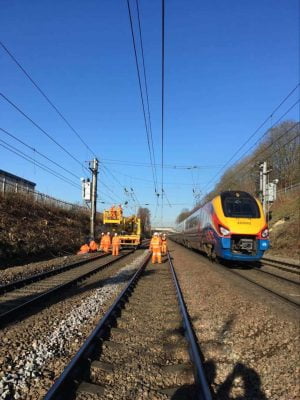 Train service running past work to repair overhead line equipment near Harpenden (Bedford)
