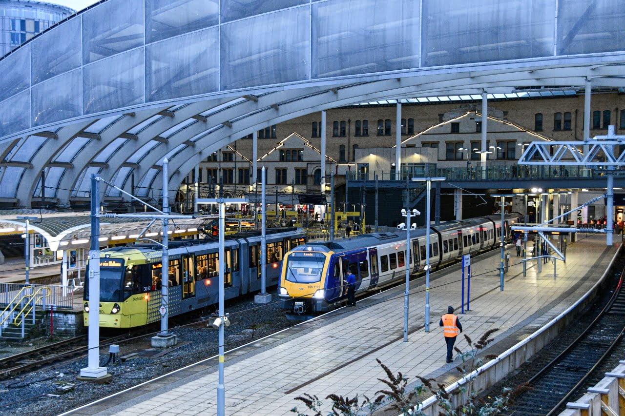 Manchester Victoria station with Northern 195 and Metrolink
