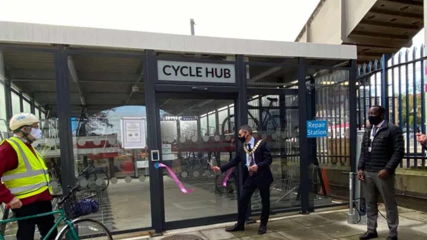 Town Mayor Cllr Simon Rubner officially opens Elstree & Borehamwood station's £200,000 cycle hub, with cyclist John Cartledge (left) and Thameslink Station Manager Marc Asamoah (right)