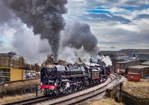 70013 Oliver Cromwell & 53808 steam out of Keighley