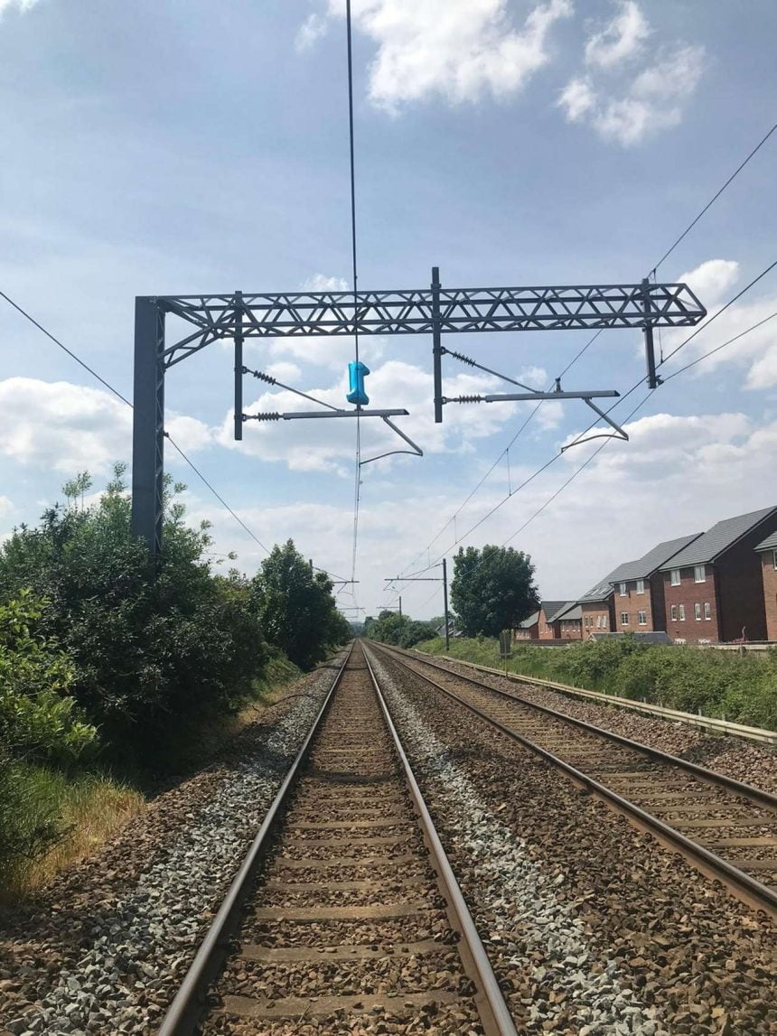 Portrait shot of the helium balloon on the overhead lines at Prescot, Liverpool