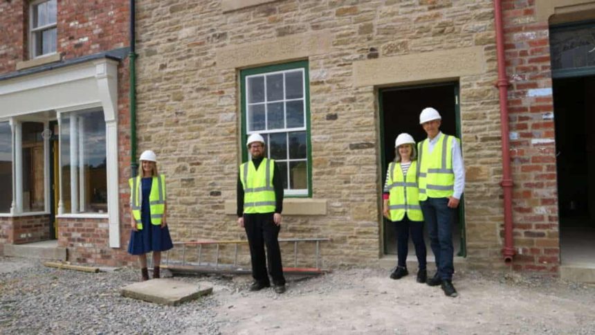 (l-r) Lisa Kaimenas and Connor Emerson of Beamish Museum with Dorothy and John Cornish, Norman’s son, in front of No. 2 Front Street terrace. The exhibit, inspired by Norman Cornish’s home, is taking shape in Beamish’s 1950s Town.