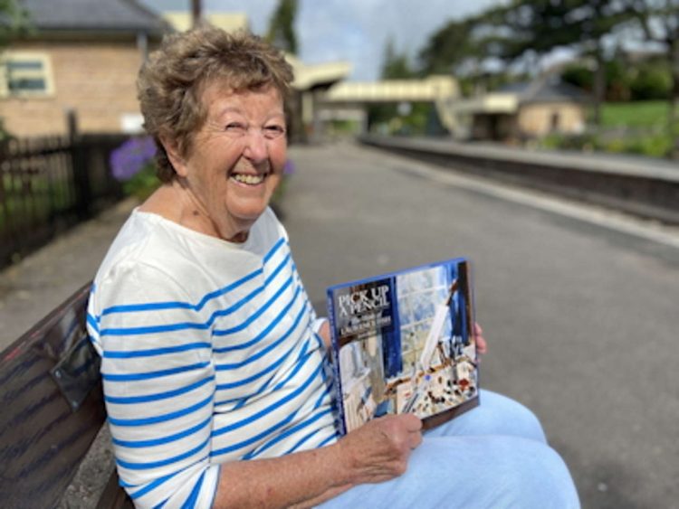 Jean Bray at Winchcombe station with her lavish book about the life and work of her late husband Laurence Fish