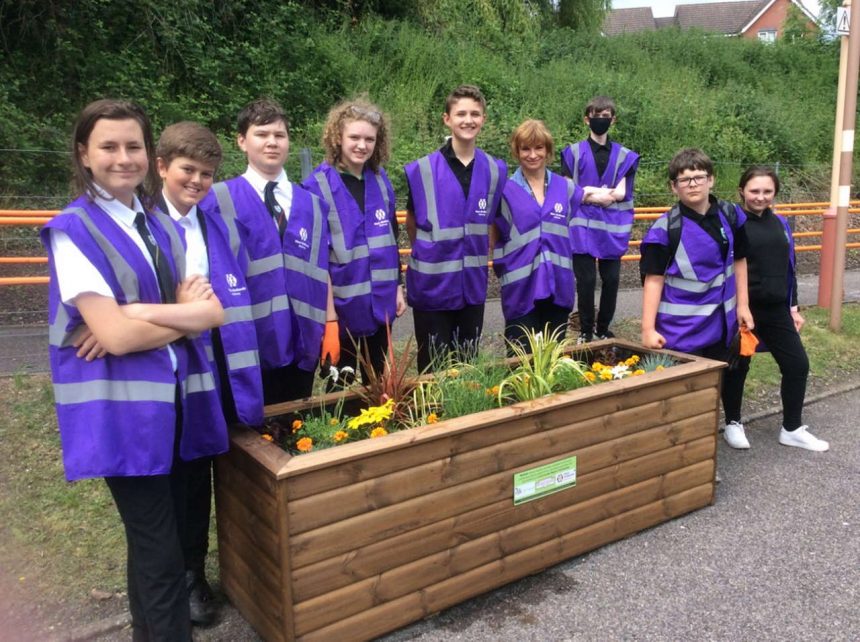 Pupils from Woodrush High School with one of the planters at Wythall railway station