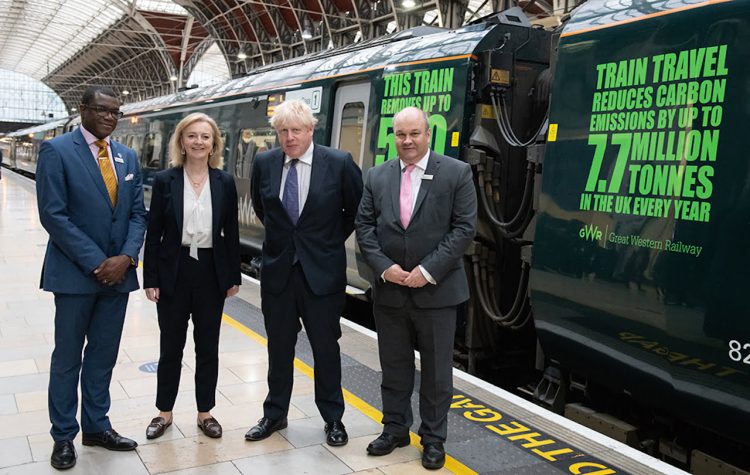 Prime Minister Boris Johnson stands with James Adeshiyan, Liz Truss, Mark Hopwood in front of the 'We Mean Green' train