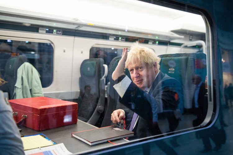 Prime Minister Boris Johnson waves from the 'We Mean Green' Train