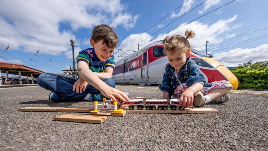 two kids playing with a new LNER toy train