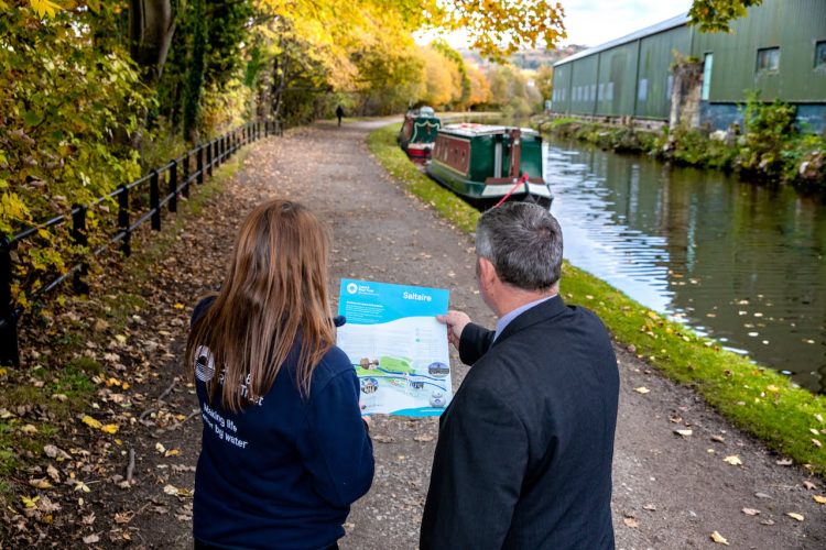 Representatives of Northern and the Canal & River Trust using the maps on a canal walk 