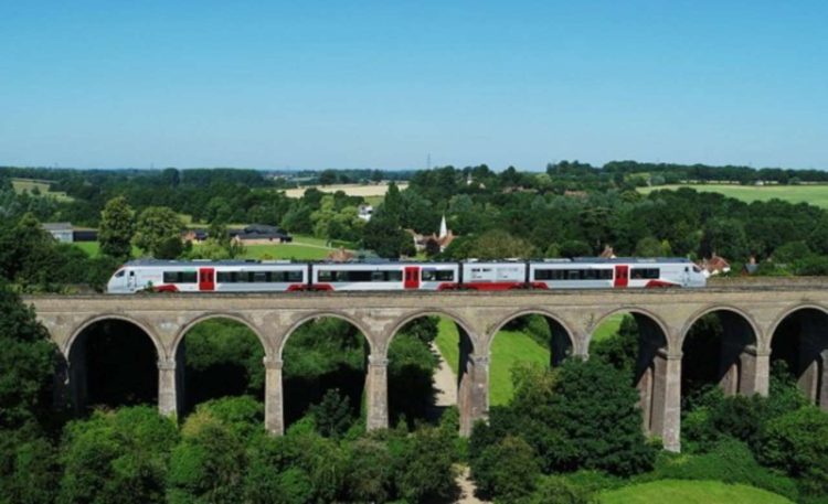 One of Greater Anglia's bi-mode trains passes over Chappel viaduct