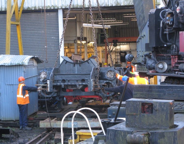 The Ivatt chassis being lowered onto the transit bogeys outside the Group's workshop