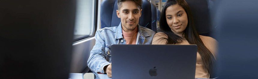 two people on the train with a laptop
