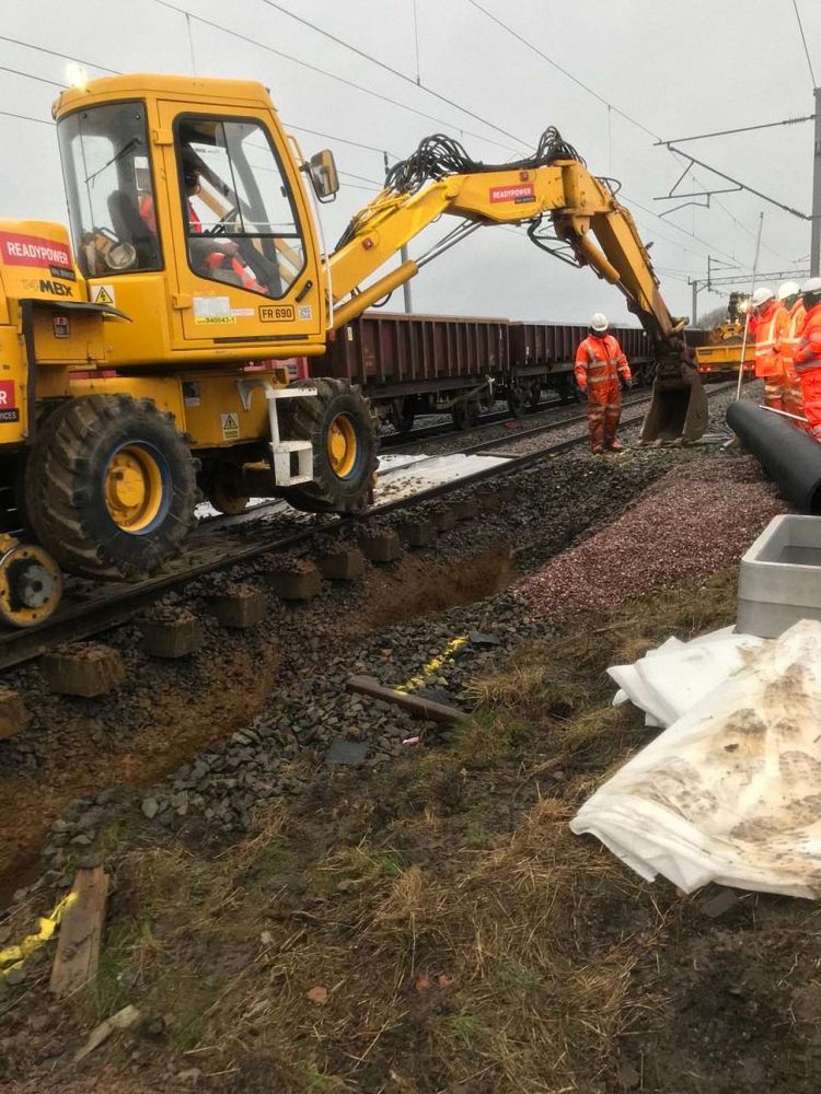 Rail mounted digger excavating new drainage at West Coast main line Kilsby upgrade
