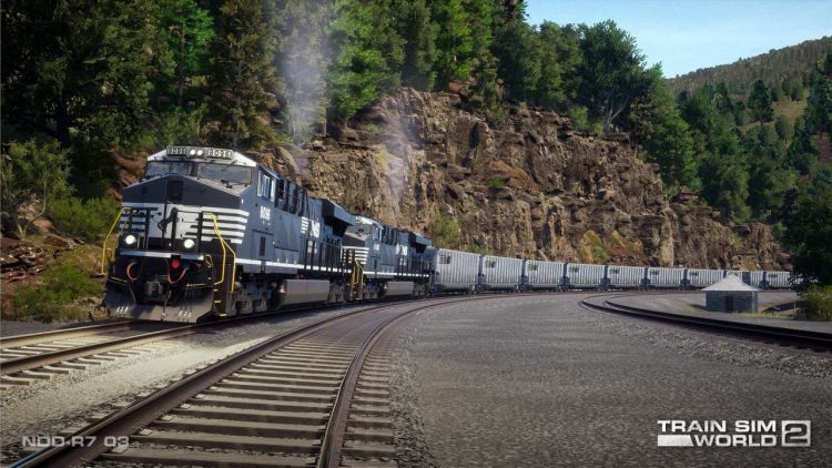 With the ancient, worn rock face of Kittanning Point as a backdrop, a pair of Norfolk Southern General Electric ES44ACs haul coal gondolas uphill around the legendary Horseshoe Curve.