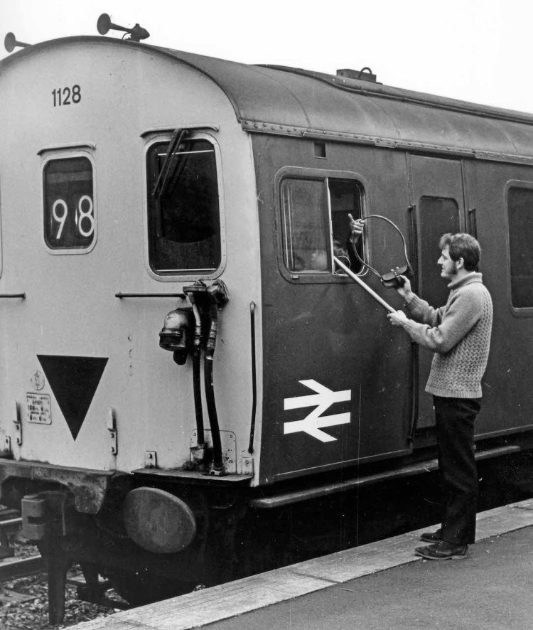 Bob Richards holds the signalling staff tube with the train at Corfe Castle on 1st Jan 1972, inside the cab is a young Peter Frost
