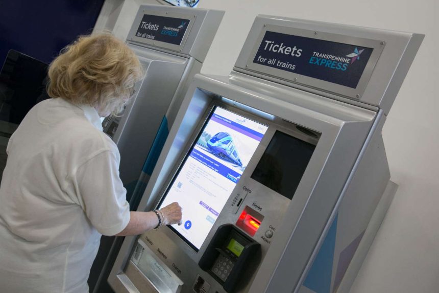 Customer using a ticket vending machine at the station