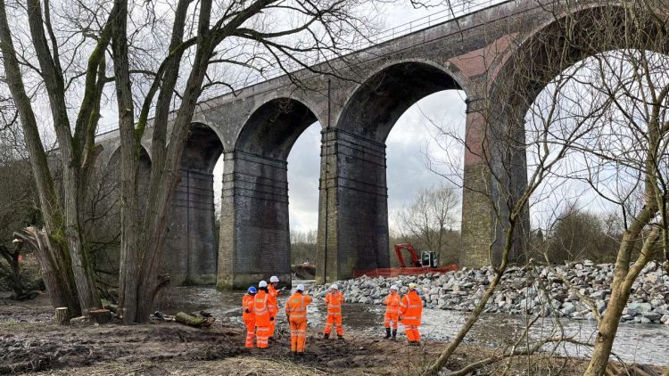 Network Rail team in front of Reddish Viaduct rock armour work