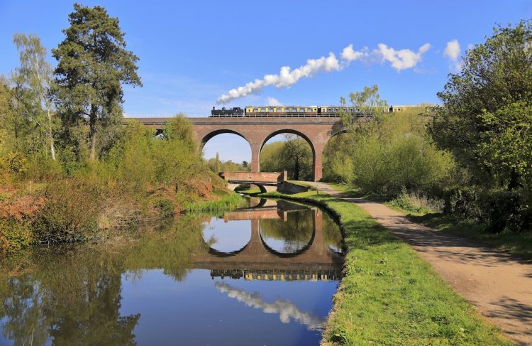 Severn Valley Railway GWR Pannier 7714 with a set of Great Western Coaches crosses over the Staffordshire and Worcestershire Canal on Falling Sands Viaduct. 