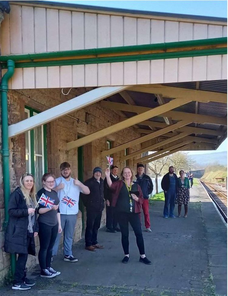 Staff at Washford on the West Somerset Railway prepare to welcome the first train to call at the station, which re-opened after being closed for many months