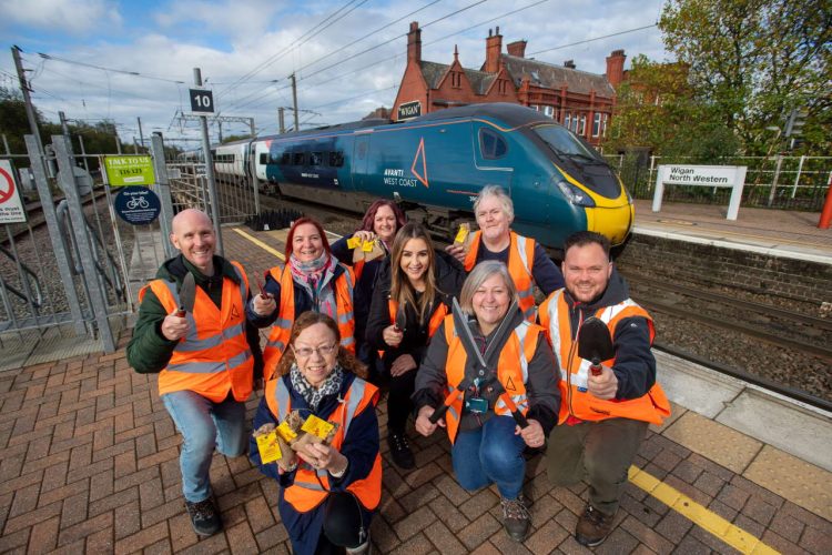 Volunteers from Avanti West Coast, Network Rail and South East Lancashire Community Rail Partnership at Wigan North Western station