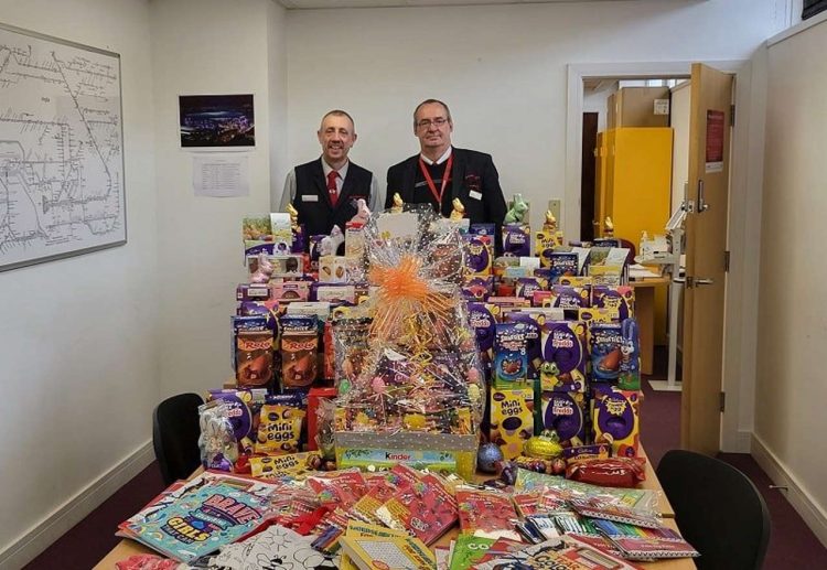 Simon Pope, relief ticket office supervisor (left) and Michael King, relief ticket office clerk (right) with the donated Easter treats for Children in Hospital