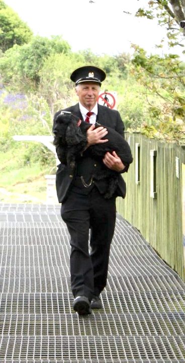 Athena the dog being carried by her owner. Athena is a regular at the railway and can normally be found in the guards van/ Duty Managers office at the end of the platform. Athena usually wears a GWR hat is ready to greet any passing dogs or their owners