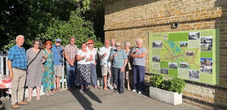Members of Stanstead Abbots Local History Society with the new history board at St Margaret's station.