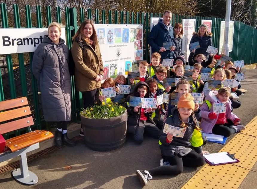 Teachers and schoolchildren from Brampton C of E Primary with the mural at Brampton rail station