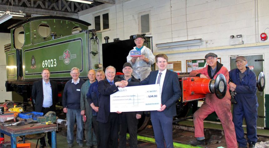 Richard Proudman and Stephen Tooley from Bachmann Europe are joined in front of ‘Joem’ by NELPG volunteers as a cheque for £504 is presented to John Hunt, Chairman of NELPG