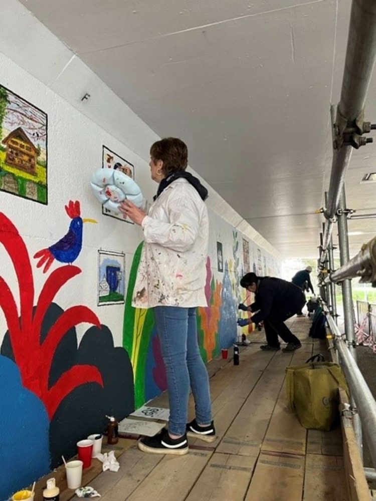 Adults painting at Meldreth underpass