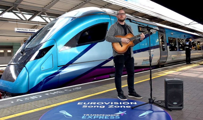 Jimmy Page plays for passengers at the TransPennine Express Eurovision Song Zone