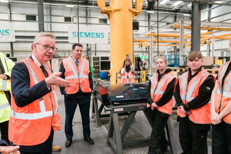 Michael Gove with apprentices at the new facility