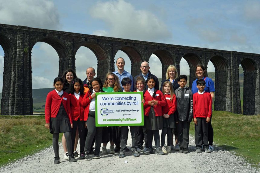 Year 5 Pupils from Barkerend Leadership Academy in Bradford admire the iconic Ribblehead viaduct with (back row) Settle to Carlisle project and social media manager Katie Chesworth, Karen Bennett from Community Rail Network, engineer Andrew Walker, Dan Coles from Community Rail Network, Carolyn Watson, director of stakeholder and community engagement at Northern, and Vice Principal of Barkerend Leadership Academy Vicki Hinchliffe.