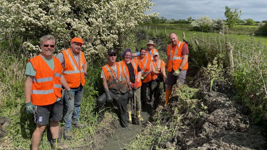 Network Rail volunteers after clearing canal feeder channel in Rugby