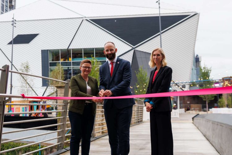 Salford City Mayor Paul Dennett, leader of Manchester City Council, Bev Craig and Jill Stephenson, principal development manager at Network Rail cutting the ribbon to open the new bridge