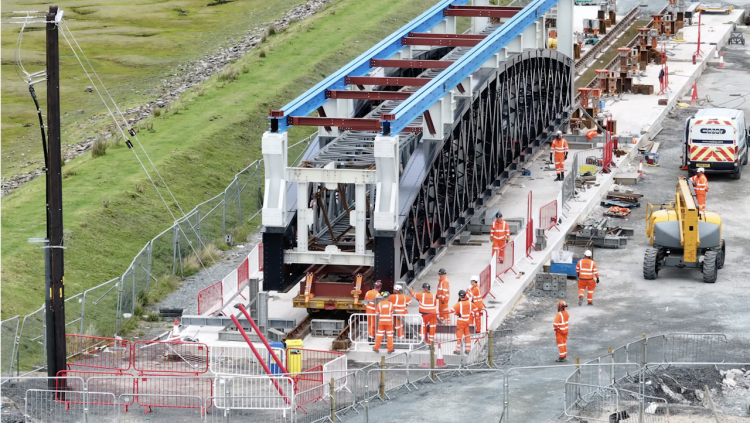 Engineers moving new span on mock railway_Barmouth