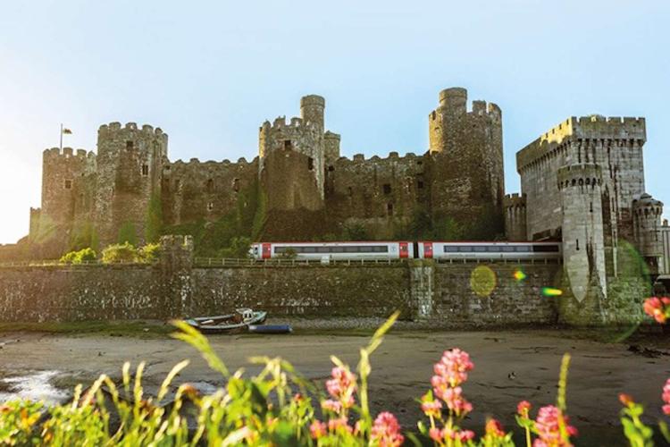 Transport for Wales train passing Conwy Castle