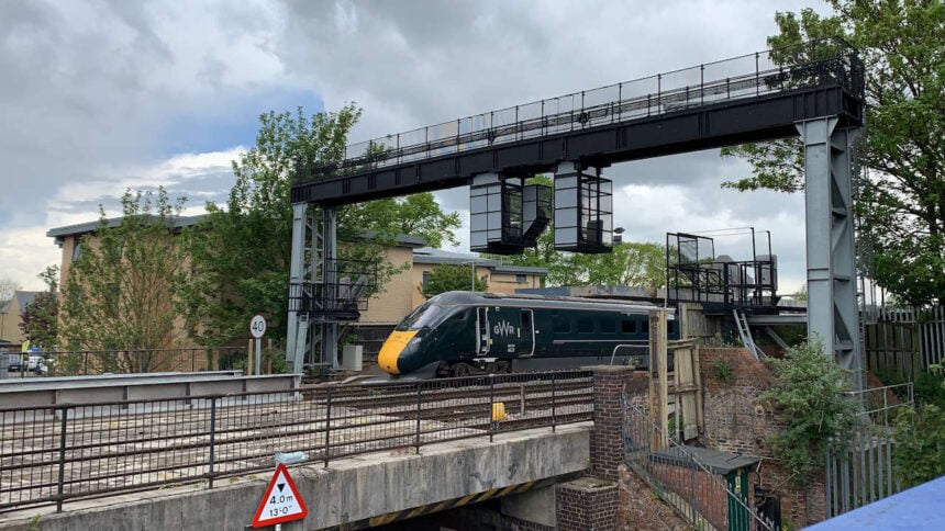 Great Western Railway train leaving Oxford station and passing over Botley Road Bridge
