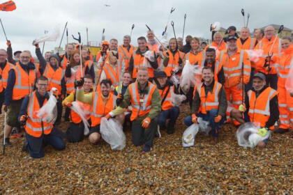 Soaking but happy with a job well done: GTR's Head of Environment Jason Brooker (centre) and the team at Brighton & Hove beach