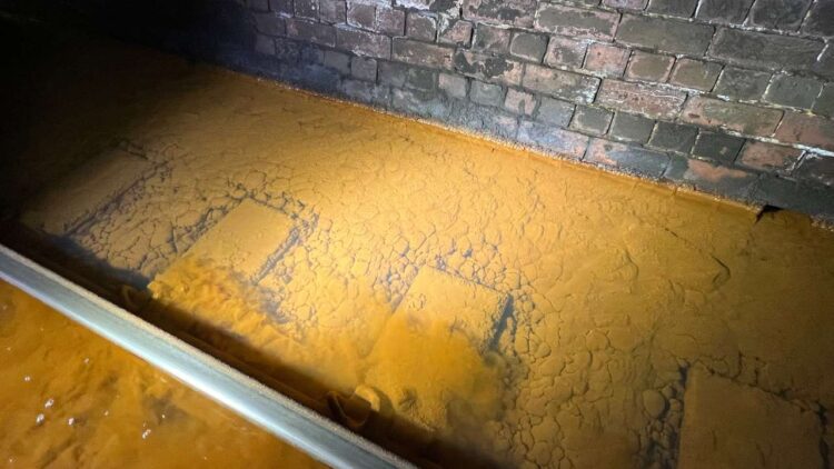Iron ochre sediment on track ballast inside Whitehaven tunnel November 2023 