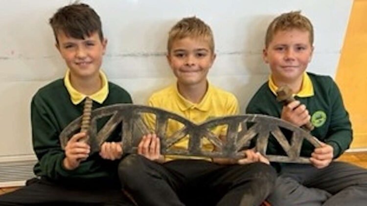 Students holding the replica of Barmouth viaduct