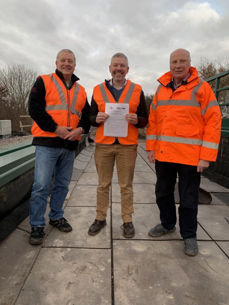 L-R Andy Fillingham, Malcolm Holmes and Richard Patching stand on the A60 bridge prior to track laying with the completed Memora.jpg
