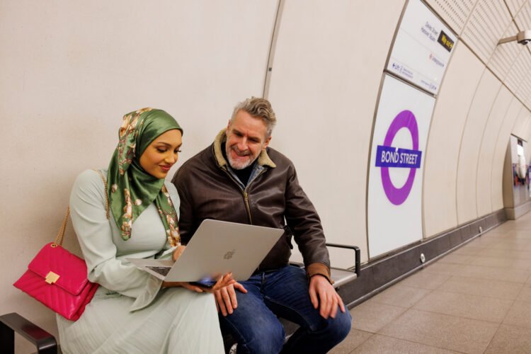 Passenger using laptop on Bond Street station