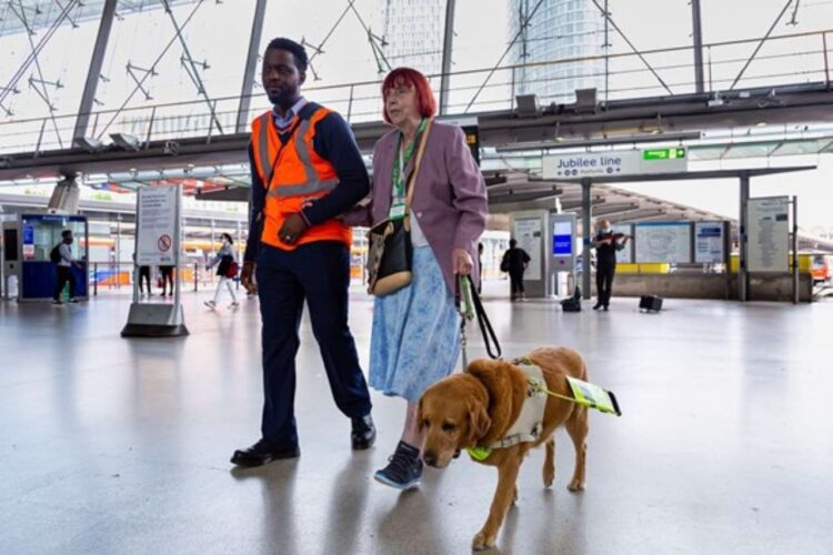 Staff accompany passenger with guide dog