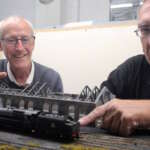 Club members Buch McInroy and John Tisi prepare a layout for the show