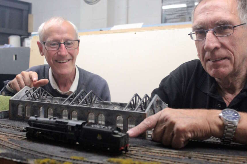 Club members Buch McInroy and John Tisi prepare a layout for the show