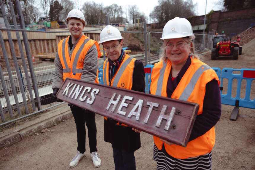 Councillor David Barker, Brandwood and Kings Heath ward, Andy Street, Mayor of the West Midlands, and Councillor Liz Clements, Birmingham City Council cabinet member for transport, take delivery of the historic Kings Heath Station sign.